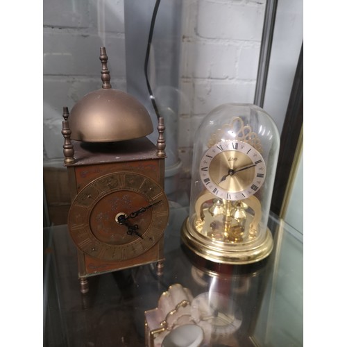 213 - Old brass clock together with schatz mantle clock.