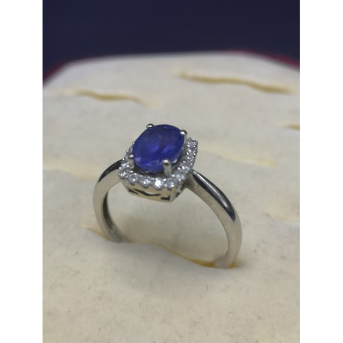 5a - 14kt white gold diamond and blue stone ring. 3.3 grams.