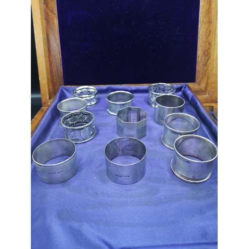 17a - Collection of 11 silver Hall marked napkin rings 296 grams..