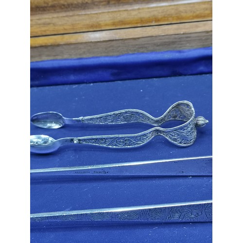 46 - Pair of sterling silver Oriental tongs together with pair of silver fillagree tongs.