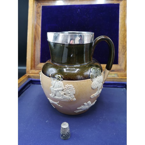 76 - Early Royal doulton lambeth ware jug with silver Hall marked metal rim.