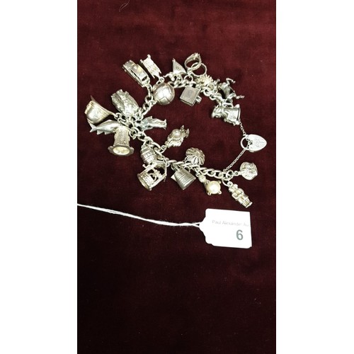 6 - Heavy silver charm bracelet with 22 silver / white charms 88 Grams.