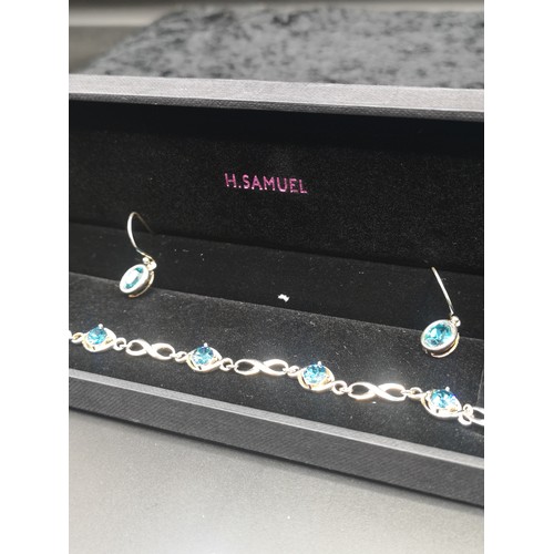 54a - Silver bracelet set with blue stone together with matching earrings.