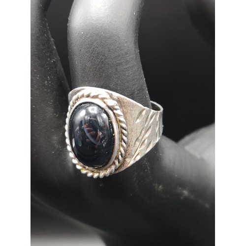 38a - Silver ornate ring with black stone setting.