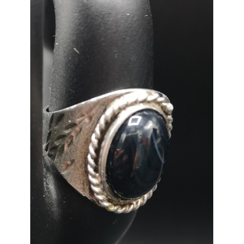 38a - Silver ornate ring with black stone setting.