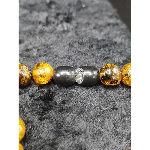 40 - Set of Amber style beads. Has damage to grey end.