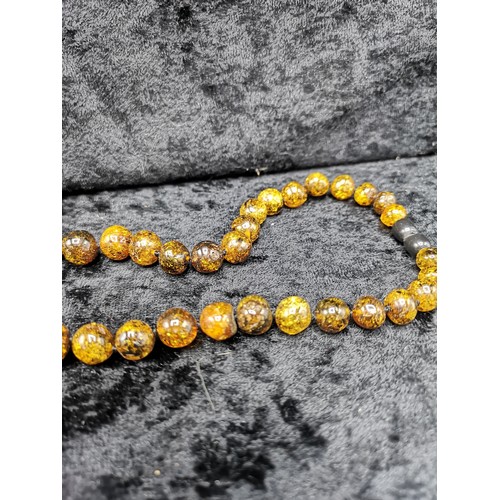 40 - Set of Amber style beads. Has damage to grey end.