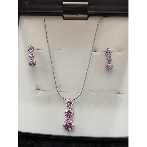 45a - Silver necklace and earring set in pink stones.
