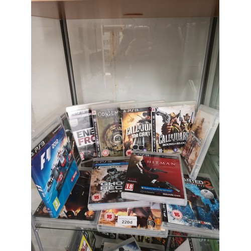 220d - Shelf of PlayStation 3 games.
