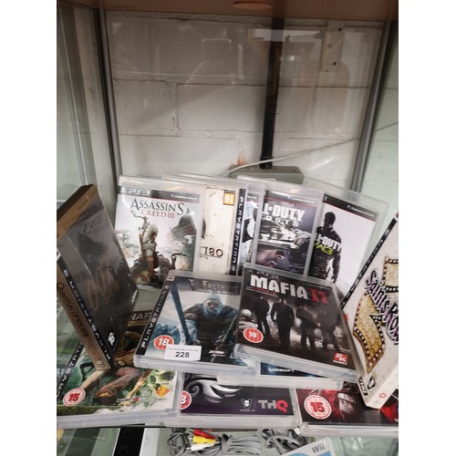 228 - Shelf of PlayStation 3 games.