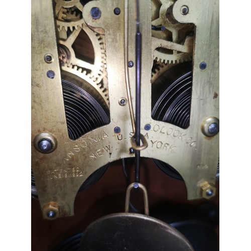 242 - Sonia clock Co New York USA light oak mantle dated 18th June 1882 with pendulum.