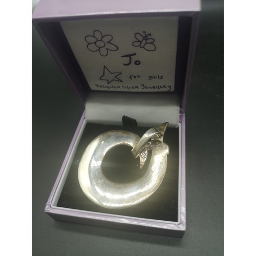 141 - Silver abstract pendant.