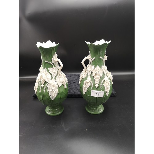 89 - Pair of delicate victorian green vases with raised out white porcelain. Both af.
