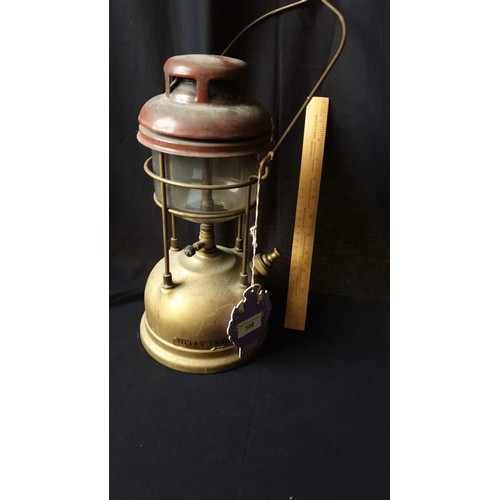 51 - Large Storm Tiley lamp complete with glass shade.