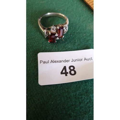 48 - Ornate ring set with red, clear stones.