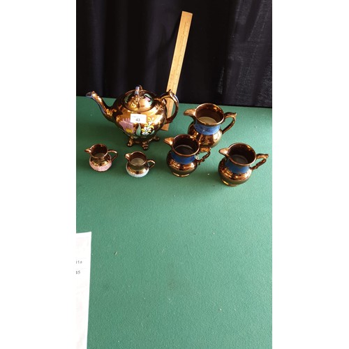 43 - Victorian 3 piece lustre tea set together with victorian lustre set of 3 jugs.