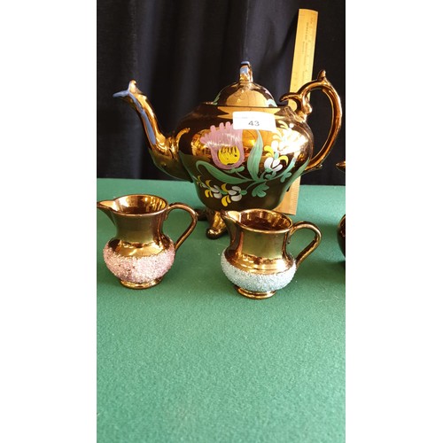 43 - Victorian 3 piece lustre tea set together with victorian lustre set of 3 jugs.