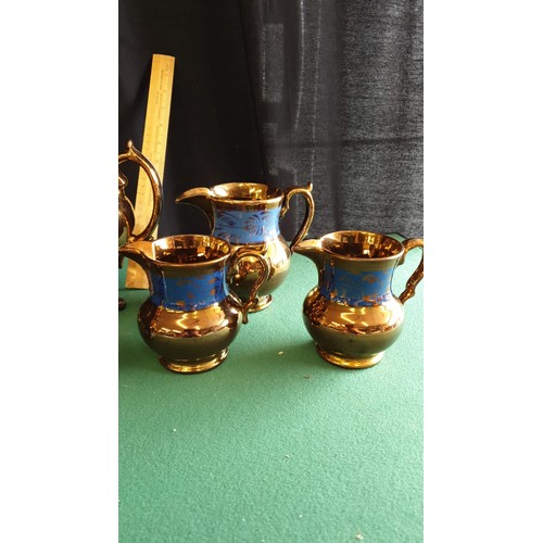 43 - Victorian 3 piece lustre tea set together with victorian lustre set of 3 jugs.