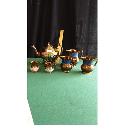 43 - Victorian 3 piece lustre tea set together with victorian lustre set of 3 jugs.