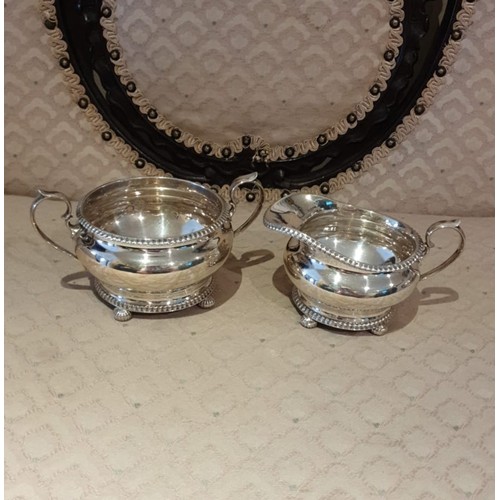 1a - 3 piece silver Hall marked tea service on pad feet serrated edges to top and bottom. 900 grams.