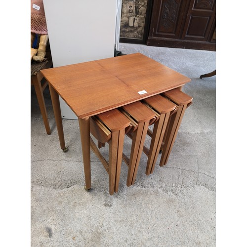 297 - Teak mid century nest of folding tables.