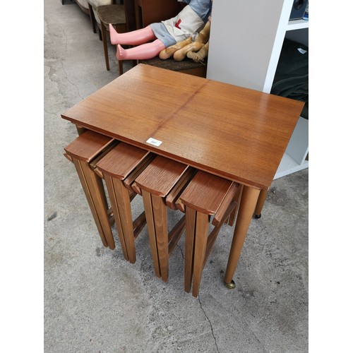 297 - Teak mid century nest of folding tables.