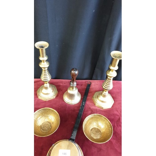 146 - Pair of brass candle sticks , brass school bell , brass scoop pot together with 2 Arabic .