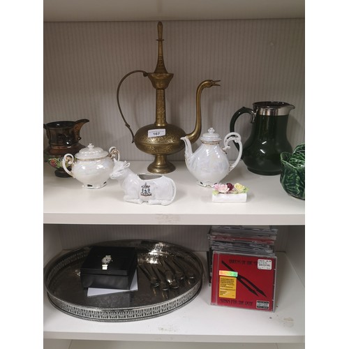 167 - 2 Shelves of collectables includes large indian style teapot , collection of cds etc .