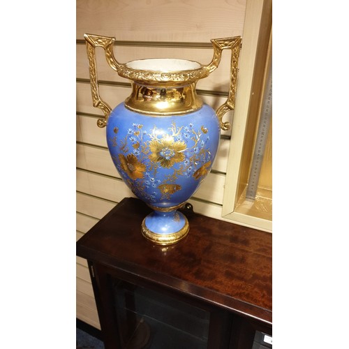 119 - Large impressive  Victorian  vase with gilded handles slight crack to body stands 46 cms tall .