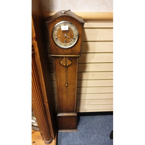 113 - Oak cased grandmother  clock with key no pendulum  but ticks.