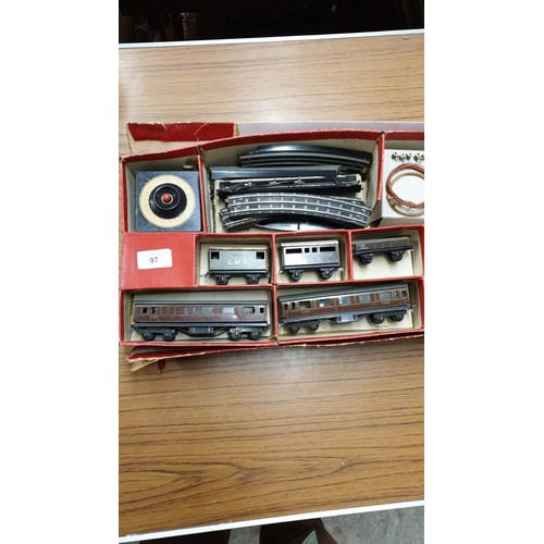 97 - Early tin plate clockwork train set with original bakelite and metal controllers.