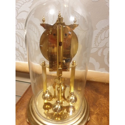 137 - Brass German Koma clock with glass dome .