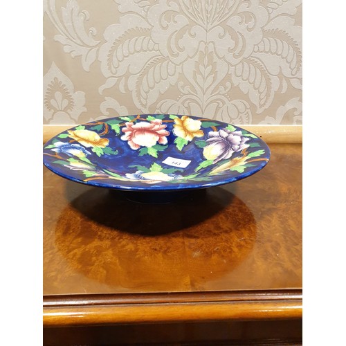 143 - Maling blue lustre backgrounded bowl / wall charger with flower design .