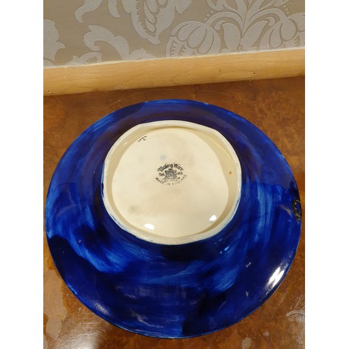 143 - Maling blue lustre backgrounded bowl / wall charger with flower design .