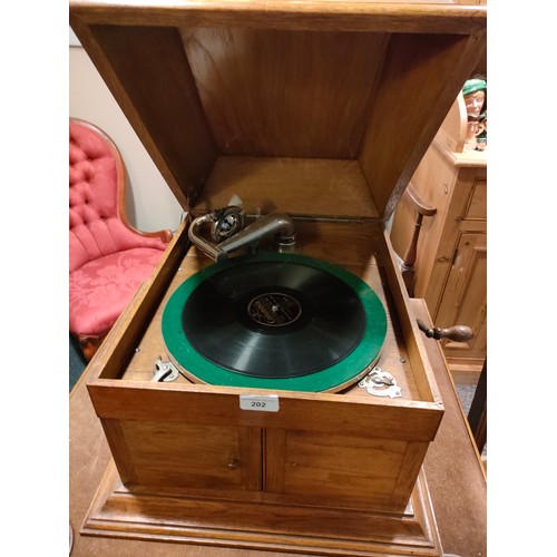 202 - 1900S Early oak Gramaphone complete with records and still plays .