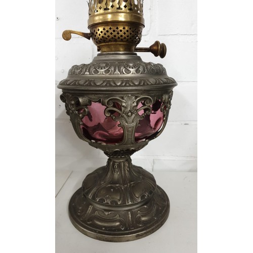 176a - Stunning Victorian Cranberry glass oil lamp with Cast Metal base rising to brass lamp fittings with ... 