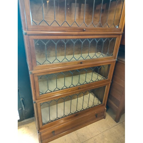 239 - Beautiful example of a Wernicke 4 tier book case with leaded glass design .