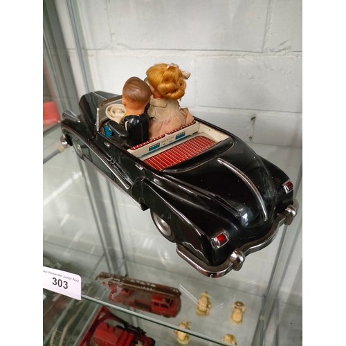 303 - Vintage metal electric car with figures in working order .