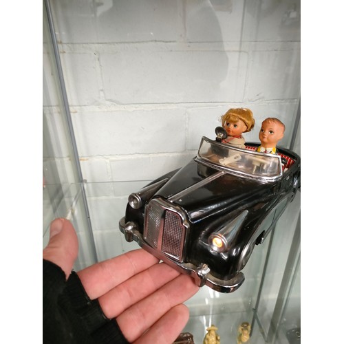 303 - Vintage metal electric car with figures in working order .