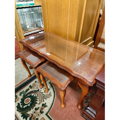 268 - Rosewood style coffee table with nest of 2 table inserted with glass preserves .