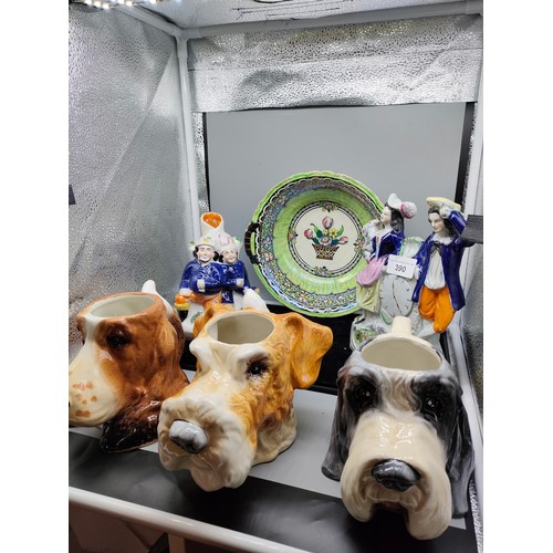 390 - Lot of collectables includes Staffordshire flat backs , 3 dog toby jugs etc .