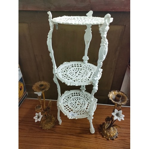 384 - Cast iron 3 tier pot stand together with pair of metal ornate candle sticks .