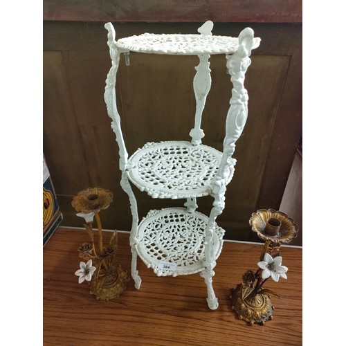 384 - Cast iron 3 tier pot stand together with pair of metal ornate candle sticks .