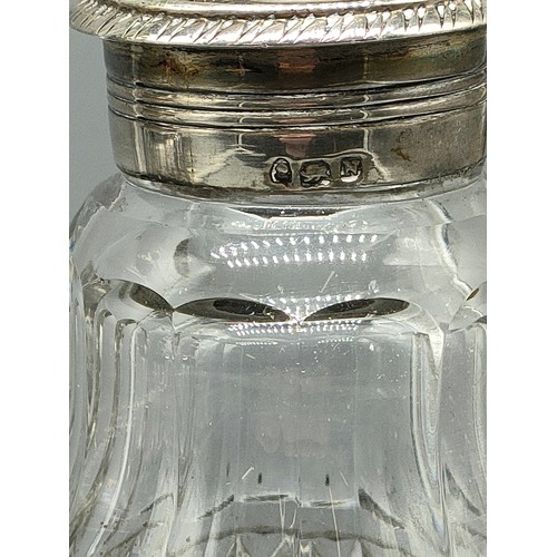 94 - Pair of silver hall marked topped bottles with glass sugar sifters .