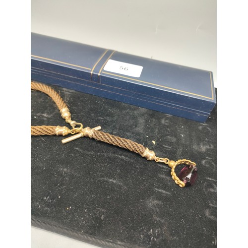 56 - Antique braided hair Albert chain with gilt metal and amethyst fob.