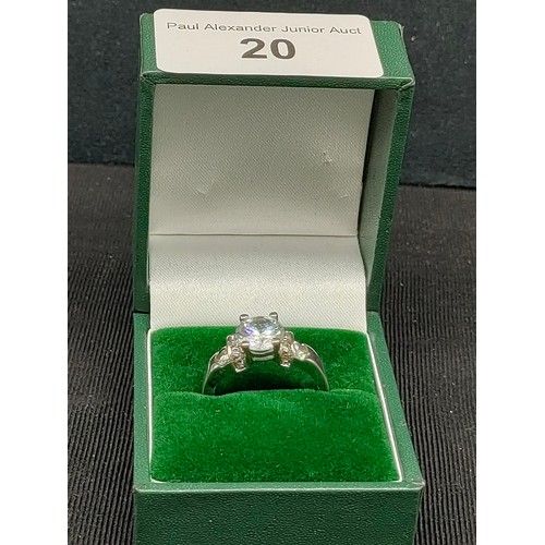 20 - Silver ring set with clear stone .