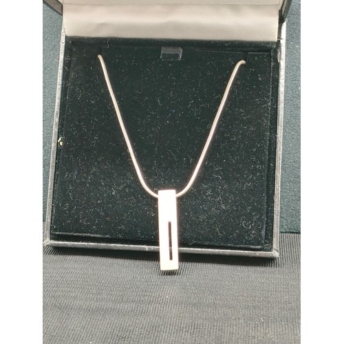 17a - Silver hall marked heavy ingot style pendant on chain.