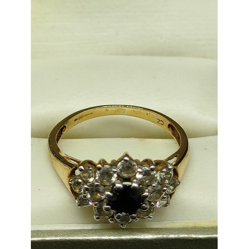 4a - 9ct gold ring set with clear and blue stones .