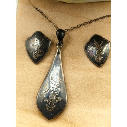 2c - Siamese silver necklace and earring set .