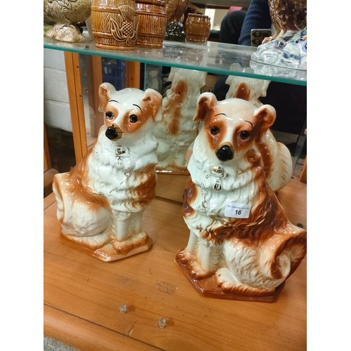 16 - Pair of large boness pottery dog figures with glass eyes .